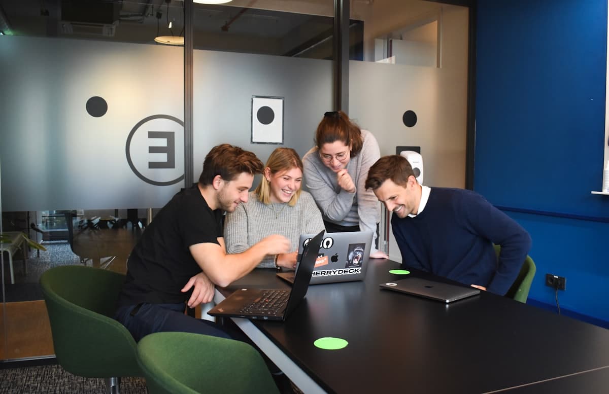 Colleagues working together at laptops in a shared office